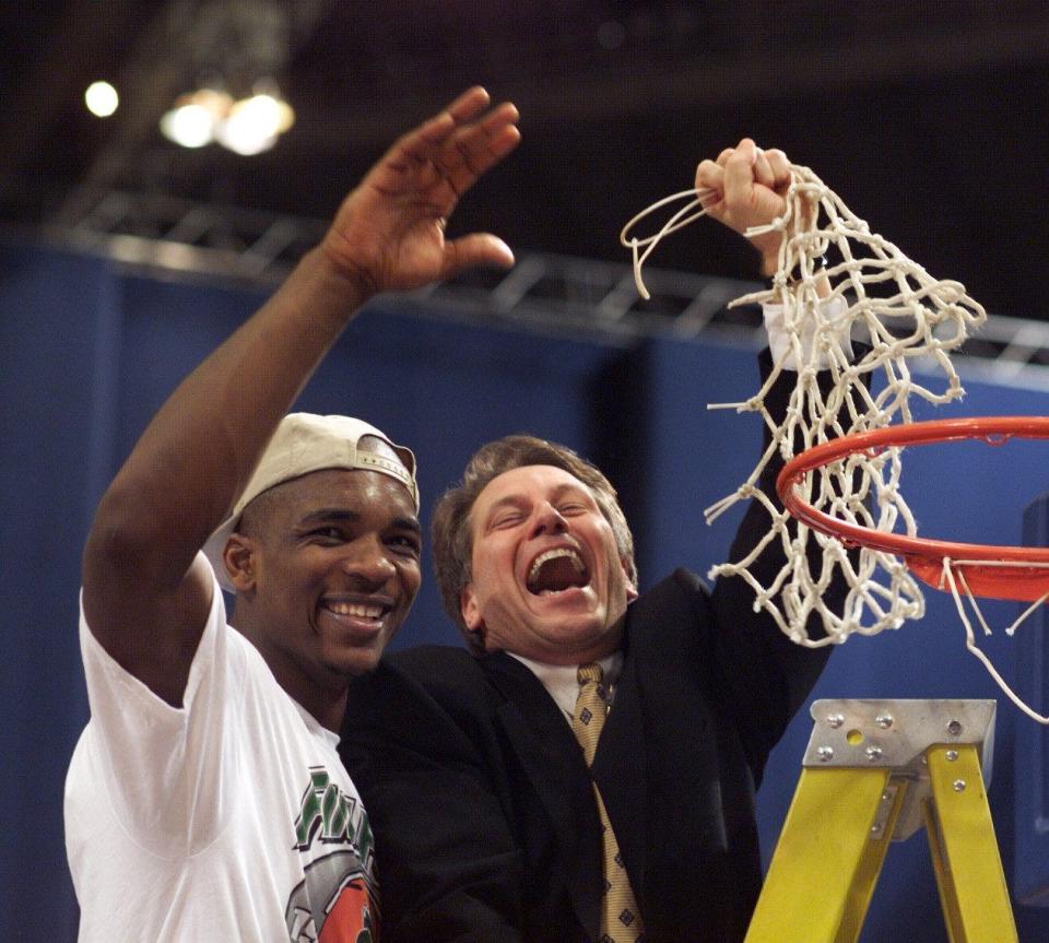 Michigan State’s Antonio Smith and head coach Tom Izzo celebrate with the cut net after their their 73-66 win over Kentucky during their NCAA Midwest Regional Final game Sunday March 21, 1999, at the Trans World Dome in St. Louis, Mo. MSU won the right to face Duke in the Final Four.