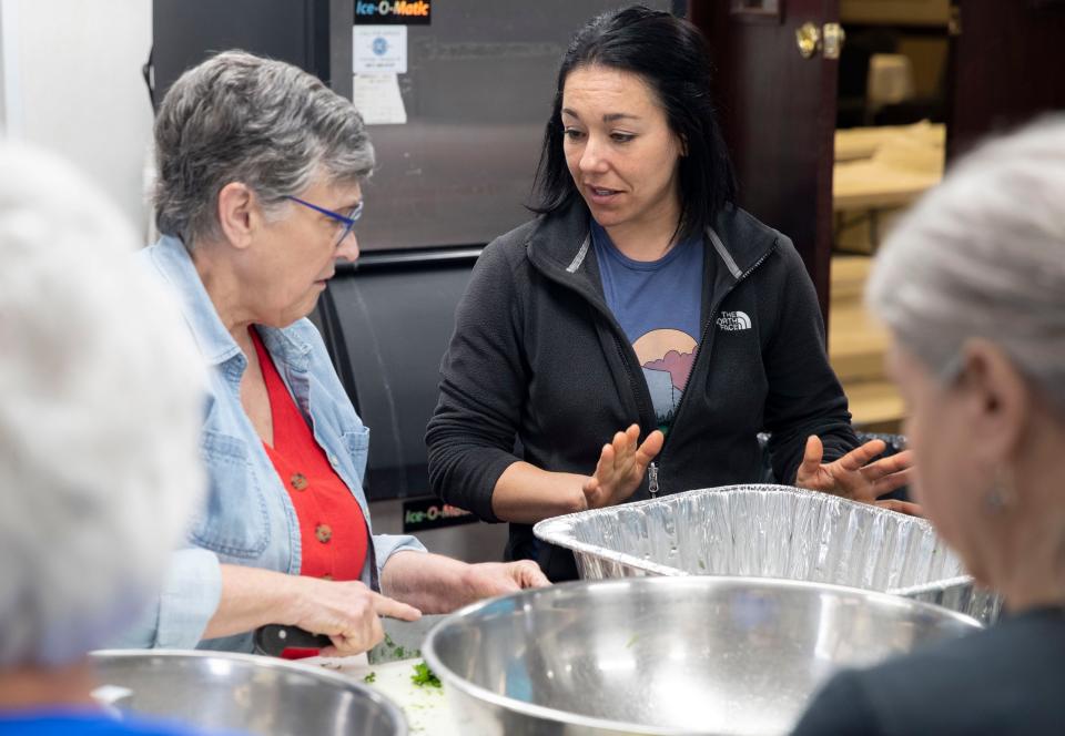Madeleine Donnelly speaks with Lydia Mims as they prepare spanakopita for the Memphis Greek Festival on Saturday, March, 2022, at at Annunciation Greek Orthodox Church in Memphis. The festival runs May 20-21, but food preparation began in January. 