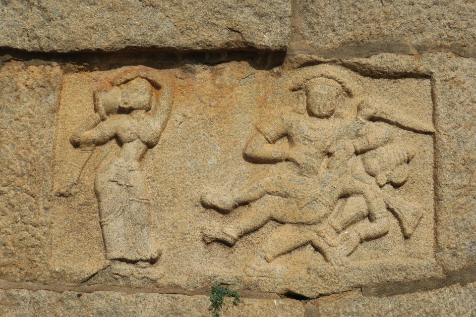 Sculpture of Bhima killing Dushasana with Draupadi looking at it. This depicts a tale from Mahabharatha. The sculpture is present at Bhima's Gate, Hampi, India