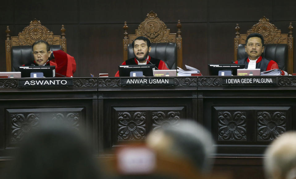 Chief Judge Anwar Usman, center, leads the session during the first hearing of a challenge to the results of April's presidential election at the Constitutional Court in Jakarta, Indonesia, Friday, June 14, 2019. The losing candidate former Gen. Prabowo Subianto claims there was massive electoral fraud and is asking the Constitutional Court to invalidate the election. The court is expected to rule by June 28. (AP Photo/Achmad Ibrahim)