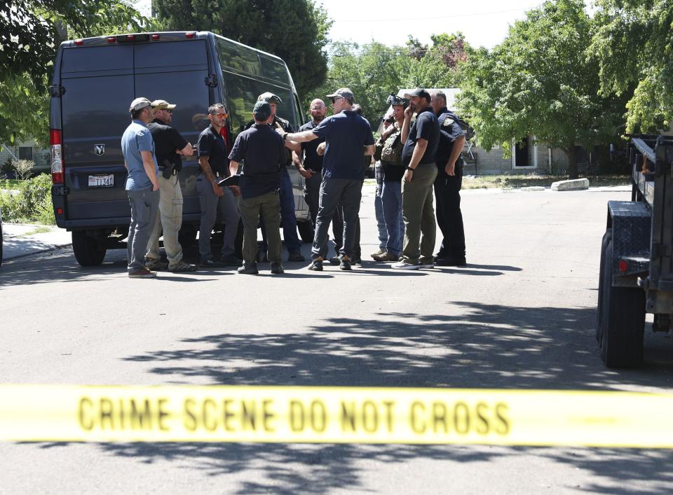 Law enforcement agents confer at the home of Craig Deleeuw Robertson, who was shot and killed by FBI agents in Provo on Wednesday, Aug. 9, 2023. Robertson posted threatening comments about President Joe Biden hours before the president was scheduled to visit Utah. | Laura Seitz, Deseret News