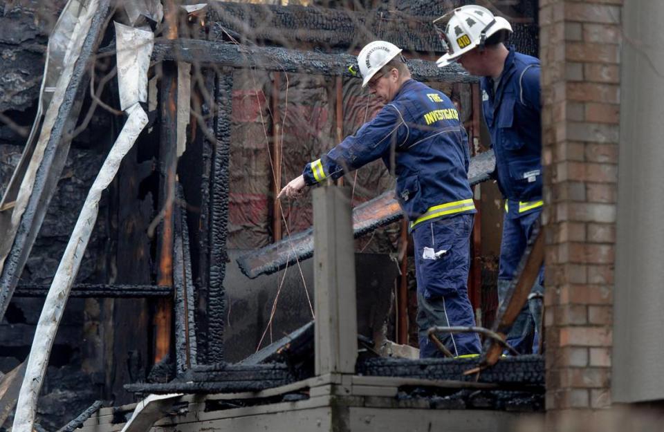 Overland Park fire investigators inspect damage to an apartment that was destroyed in a fire at the Meadowlark Hill Apartments on Thursday, Dec. 8, 2022, in Overland Park, Kan.