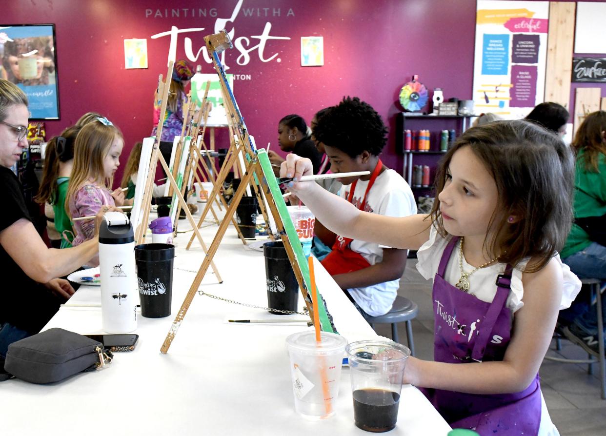 Lily Dye, 8, works on an Easter-themed painting at Painting with a Twist in North Canton.