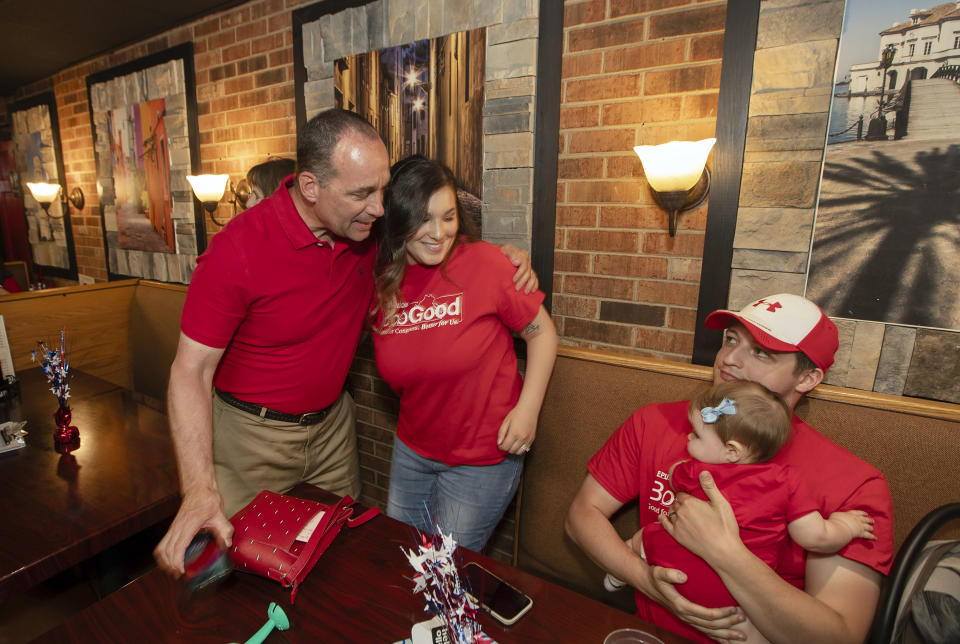 Rep. Bob Good, left, a candidate in the Republican primary for the state's 5th Congressional District, greets family members at a watch party in Lynchburg, Va., Tuesday, June 18, 2024. (AP Photo/P. Kevin Morley)