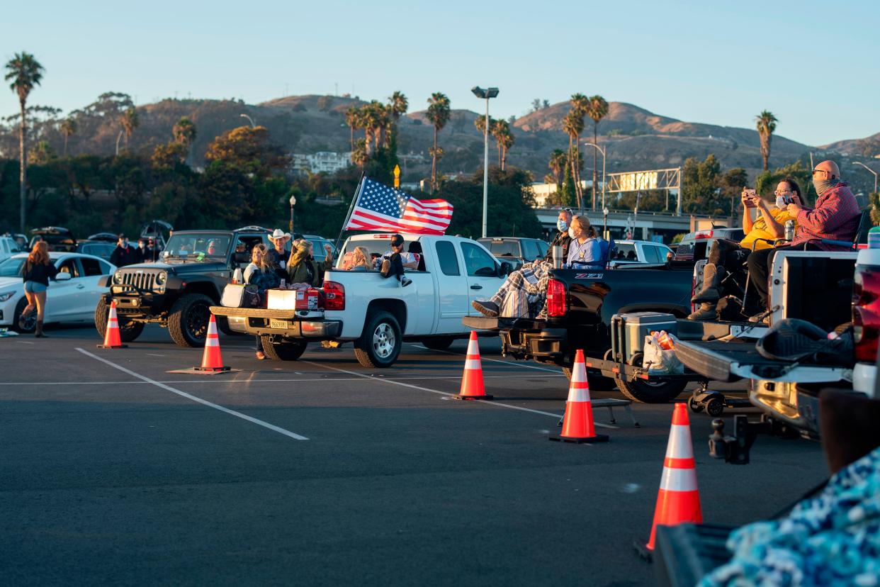 People listen to performers onstage during the drive-in live music event "Concerts in your Car" at the Ventura County Fairgrounds and Event Center in Ventura, Calif. on July 11, 2020, amid the coronavirus pandemic.