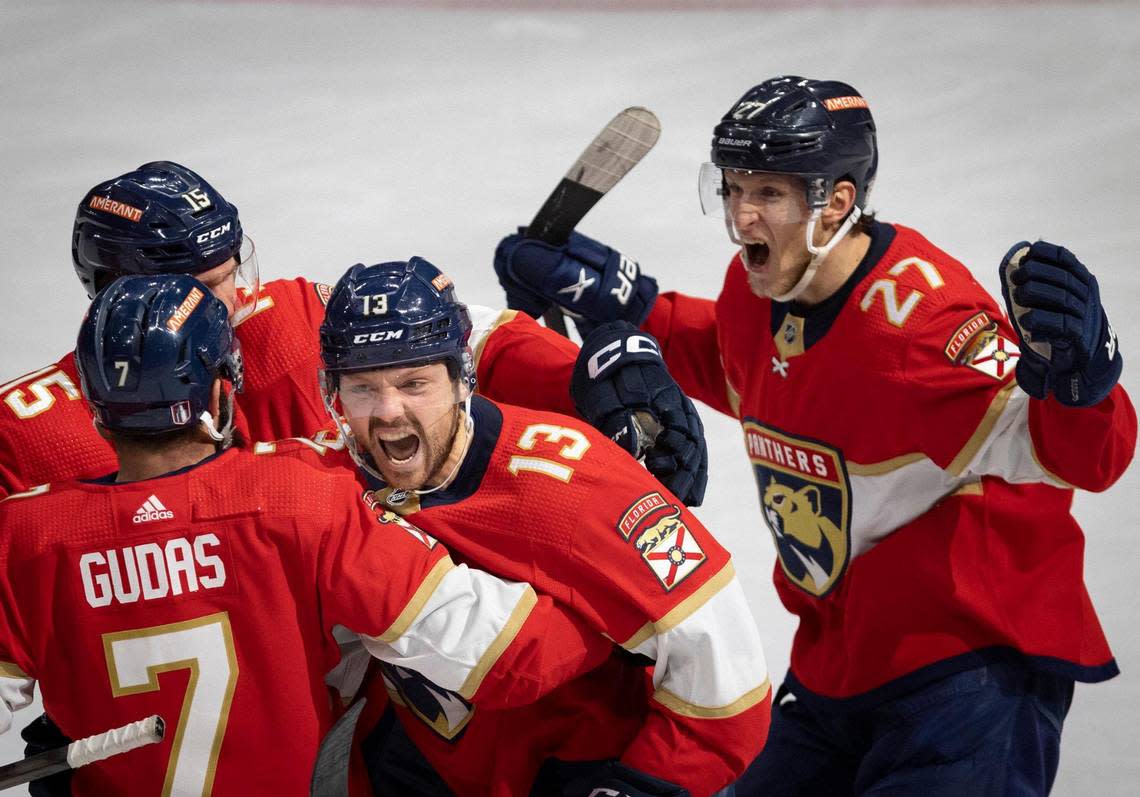 Florida Panthers center Sam Reinhart (13) screams while hugging defenseman Radko Gudas (7), center Eetu Luostarinen (27), and center Anton Lundell (15) after scoring the game winning goal in overtime of Game 3 of the Eastern Conference second-round NHL Stanley Cup series on Sunday, May 7, 2023, at FLA Live Arena. The Florida Panthers won 3-2.