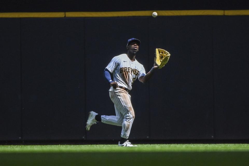 Milwaukee Brewers Jonathan Davis catches the ball of Colorado Rockies player Jose Iglesias during the fourth inning of a baseball game, Sunday, July 24, 2022, in Milwaukee. (AP Photo/Kenny Yoo)