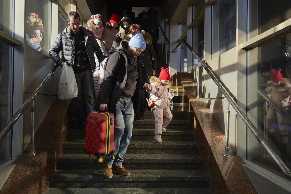 People rush to evacuation trains driving to the west of Ukraine on Feb. 26, 2022, in Kyiv, Ukraine. Explosions and gunfire were reported around Kyiv on the second night of Russia's invasion of Ukraine, which has killed scores and prompted widespread condemnation from U.S. and European leaders.