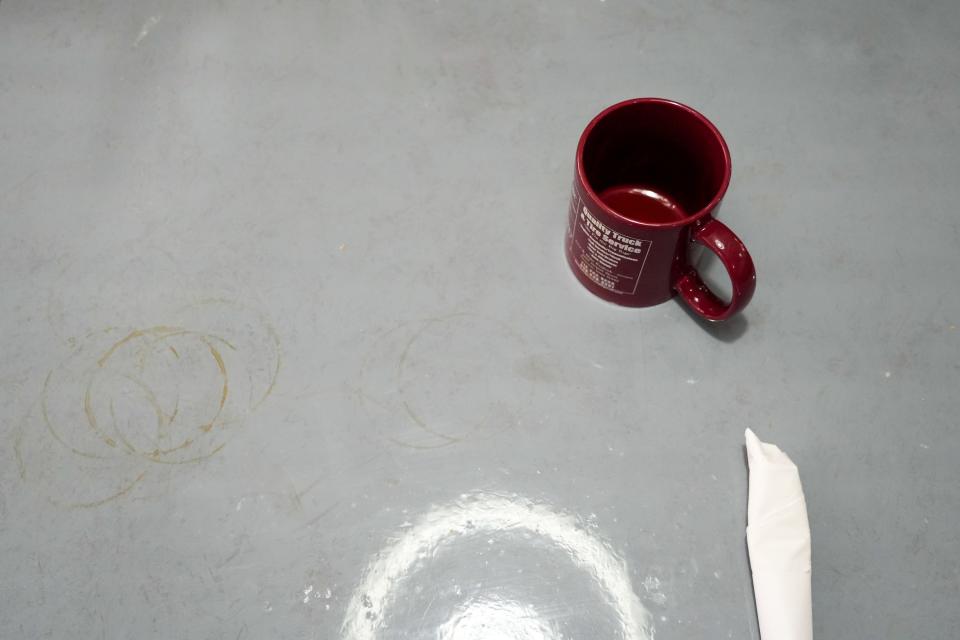 A coffee mug sits on a table at Cronk's Café.