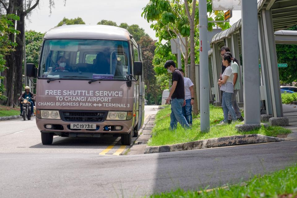 Workers take a free campus shuttle in Changi Business Park. (Photo: Aparna Nori/Bloomberg)