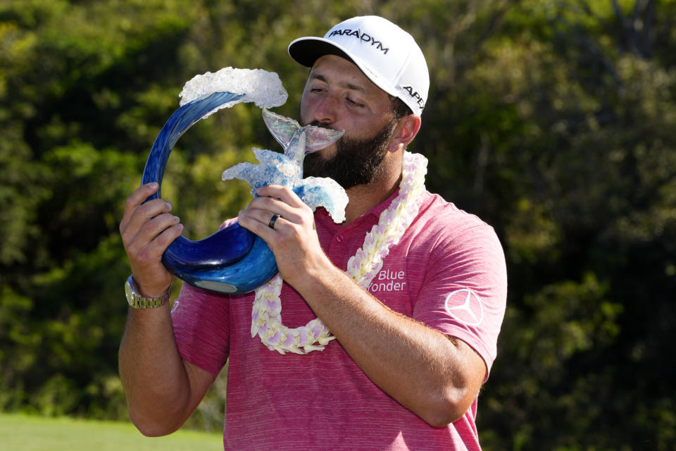 Jon Rahm, of Spain, kisses the champions trophy after the final round of the Tournament of Champions golf event, Sunday, Jan. 8, 2023, at Kapalua Plantation Course in Kapalua, Hawaii. (AP Photo/Matt York)