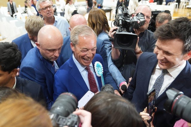 Nigel Farage surrounded by reporter, photographers and camera crew