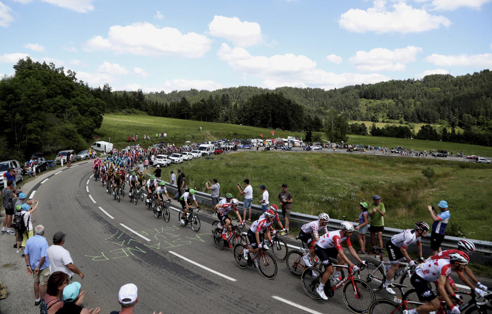 The pack rides during the ninth stage of the Tour de France cycling race over 170.5 kilometers (105.94 miles) with start in Saint Etienne and finish in Brioude, France, Sunday, July 14, 2019. (AP Photo/Thibault Camus)