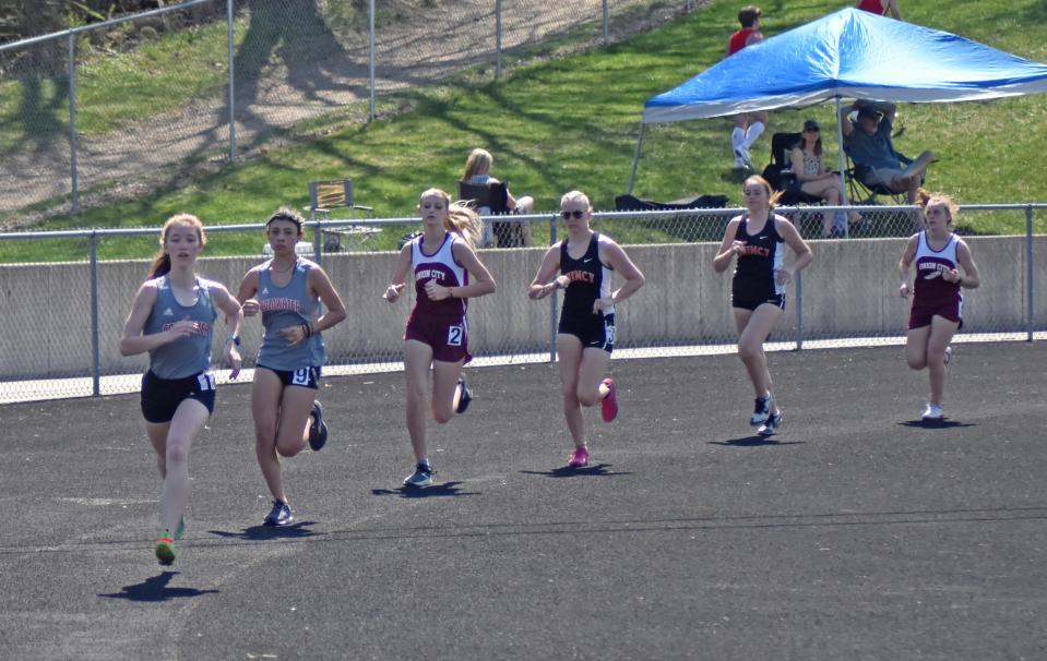 The competitors of the 1600 meter run round the second first turn Saturday. Pictured are, from front to back, race winner Lainey Yearling (CW), Coldwater's Eysha Chavez, Union City's Skyler Fraley, Quincy's Sadie Miler, Quincy's Libby Butchart, and Union City's Elizabeth Arlt.