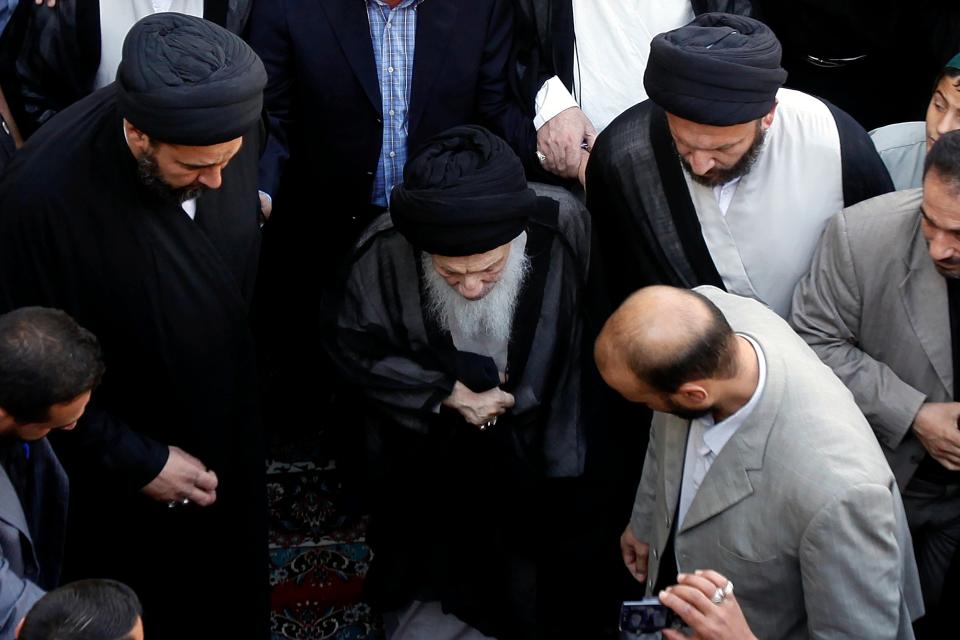 In this image dated Saturday, Aug. 29, 2009, Grand Ayatollah Sayyid Mohammed Saeed al-Hakim, center, attends a funeral procession of revered Shiite leader Abdul-Aziz Al-Hakim in Najaf, Iraq. Mohammed Saeed al-Hakim, one of Iraq's most senior and influential Muslim Shiite clerics, has died, members of his family said. He was 85. (AP Photo/Hadi Mizban)