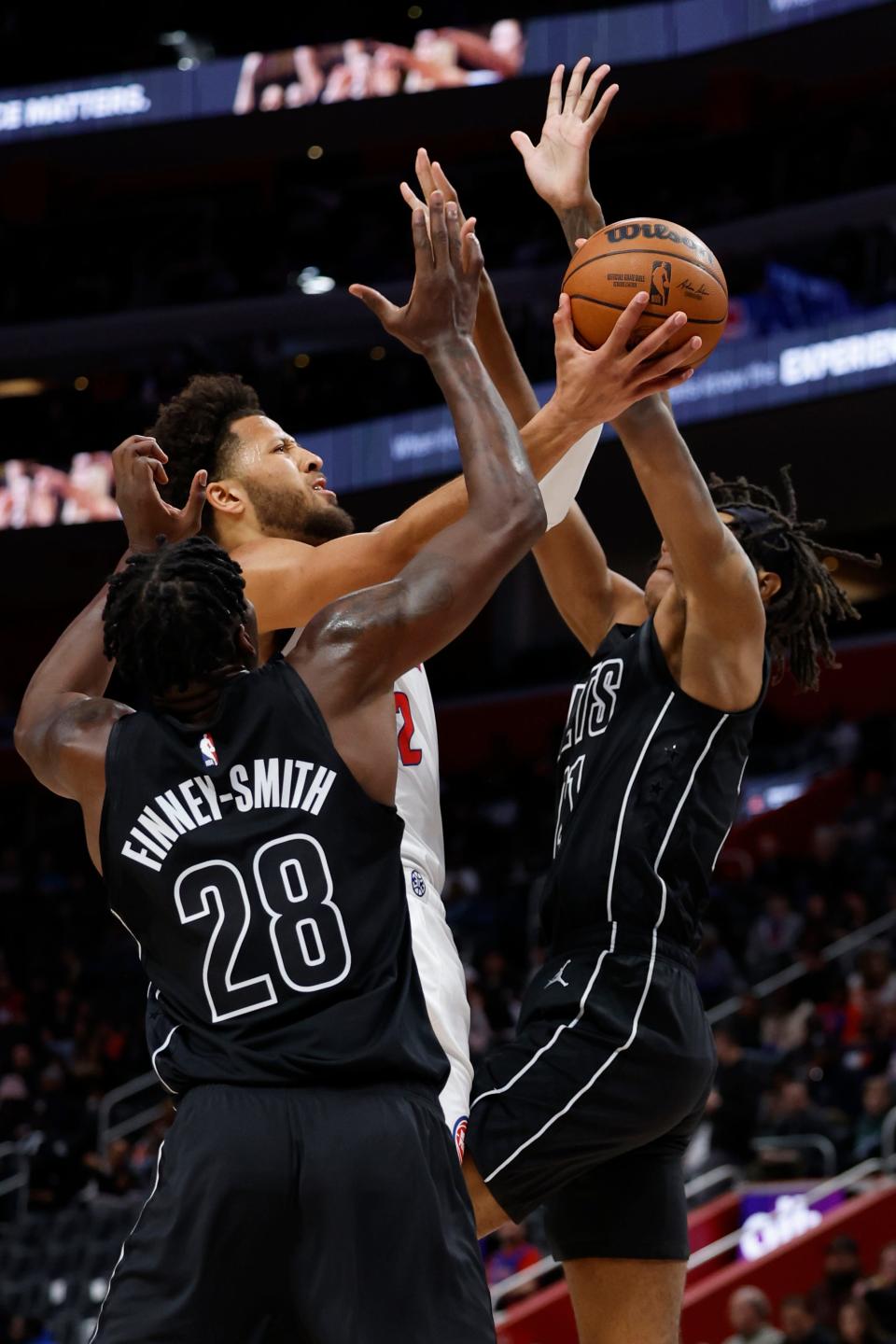 Detroit Pistons guard Cade Cunningham (2) shoots on Brooklyn Nets forward Dorian Finney-Smith (28) in the first half at Little Caesars Arena in Detroit on Thursday, March 7, 2024.