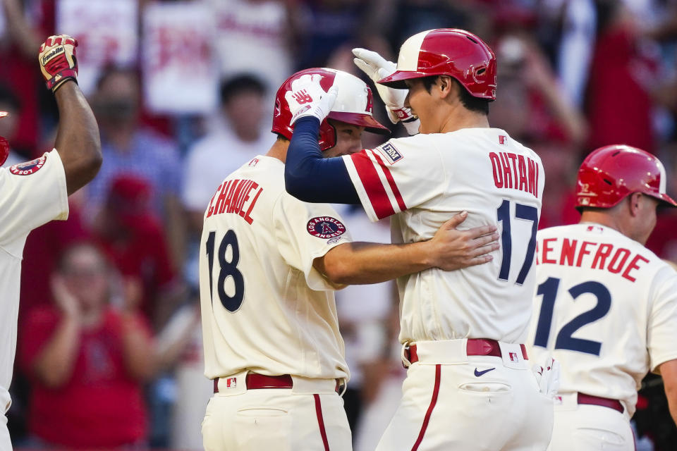 Los Angeles Angels designated hitter Shohei Ohtani (17) celebrates with Nolan Schanuel (18) after hitting a grand slam during the second inning of a baseball game against the Tampa Bay Rays, Friday, Aug. 18, 2023, in Anaheim, Calif. Hunter Renfroe, Luis Rengifo, and Nolan Schanuel also scored. (AP Photo/Ryan Sun)