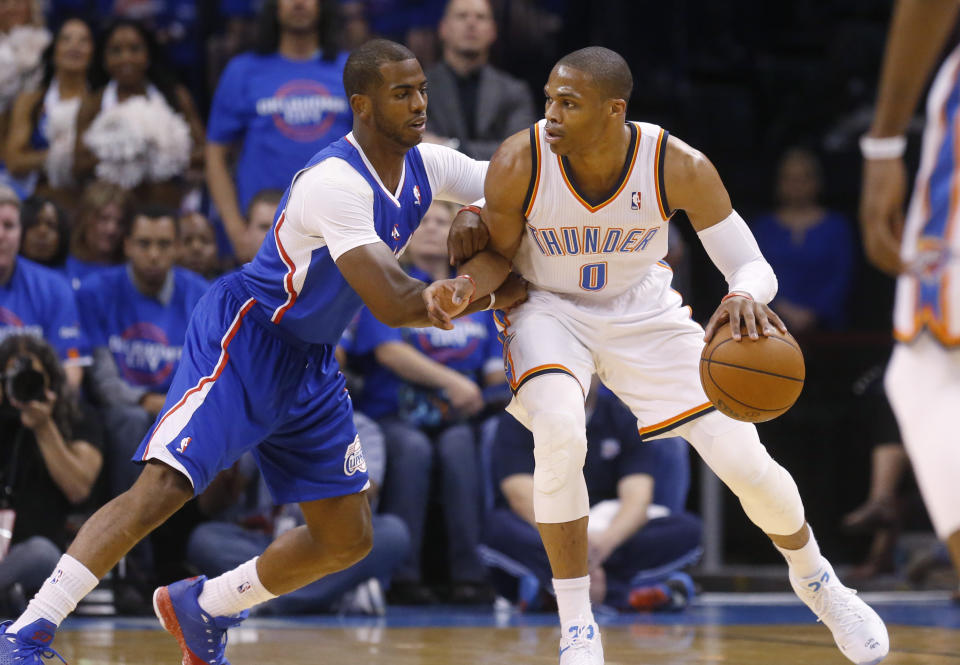 FILE - In this Monday, May 5, 2014 file photo, Oklahoma City Thunder guard Russell Westbrook (0) drives against Los Angeles Clippers guard Chris Paul (3) in the first quarter of Game 1 of the Western Conference semifinal NBA basketball playoff series in Oklahoma City. A person with knowledge of the situation says the Oklahoma City Thunder have traded Russell Westbrook to the Houston Rockets for Chris Paul, a shake up of top point guards and a move that reunites Westbrook with James Harden, Thursday, July 11, 2019. (AP Photo/Sue Ogrocki, File)