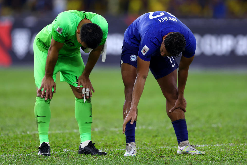 Singapore's Hassan Sunny (left) and Irfan Fandi with their hands on their knees after the 1-4 defeat by Malaysia in the AFF Mitsubishi Electric Cup. 