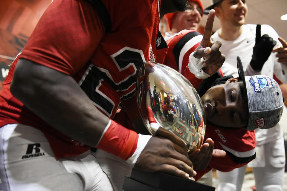 Kissing the Conference USA championship trophy