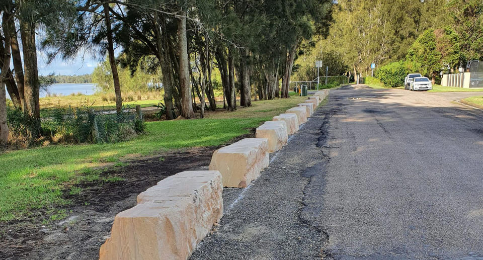 Photo of Killarney Vale street with sandstone blocks on side of road.