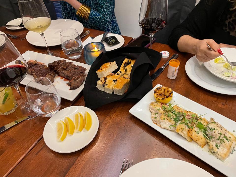 Meat, bread on a dining table.