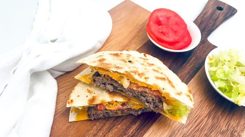 quesadilla burger on wooden board