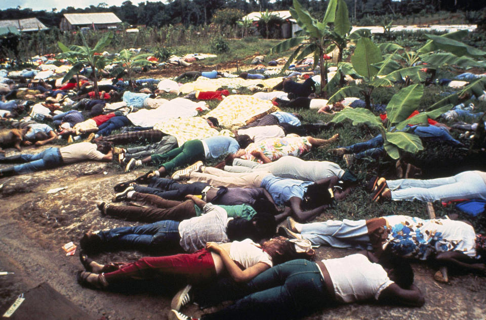 FILE - This November 1978 file photo shows the bodies of Peoples Temple mass suicide victims led by Jim Jones in Jonestown, Guyana. Dozens of Peoples Temple members in Guyana survived the mass suicides and murders of more than 900 because they had slipped out of Jonestown or happened to be away Nov. 18, 1978. Those raised in the temple or who joined as teens lost the only life they knew. They have journeyed over the past 40 years through grief over lost loved ones, feeling like pariahs, building new lives and, finally, acknowledging that many had a role in enabling the Rev. Jim Jones to seize control over his followers. (AP Photo/File)