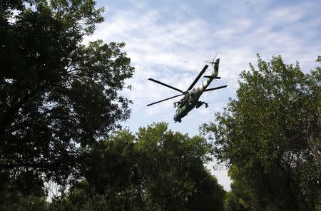 A Ukrainian helicopter Mi-24 gunship flies above a military base in the eastern Ukrainian town of Kramatorsk August 22, 2014. REUTERS/Valentyn Ogirenko