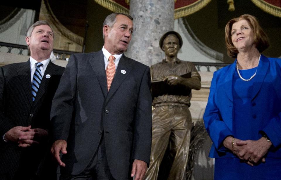 From left, Agriculture Secretary Tom Vilsack, House Speaker John Boehner of Ohio,, and Jeanie Borlaug Laube, daughter of Dr. Norman E. Borlaug, stand together in National Statuary Hall on Capitol Hill in Washington, Tuesday, March 25, 2014, in front of a statue of the late Dr. Norman E. Borlaug during an unveiling ceremony. Borlaug, an Iowa native, is known as the “Father of The Green Revolution” and his development of "miracle wheat" is credited with saving an estimated billion people around the world from hunger and starvation. He is the only American to receive the Nobel Peace Prize, the Congressional Gold Medal, the Presidential Medal of Freedom and the National Medal of Science. (AP Photo/Carolyn Kaster)