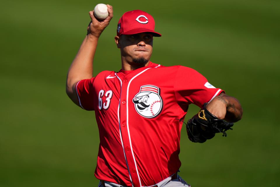 Cincinnati Reds relief pitcher Fernando Cruz (63) long tosses during spring training workouts, Friday, Feb. 16, 2024, at the team’s spring training facility in Goodyear, Ariz.