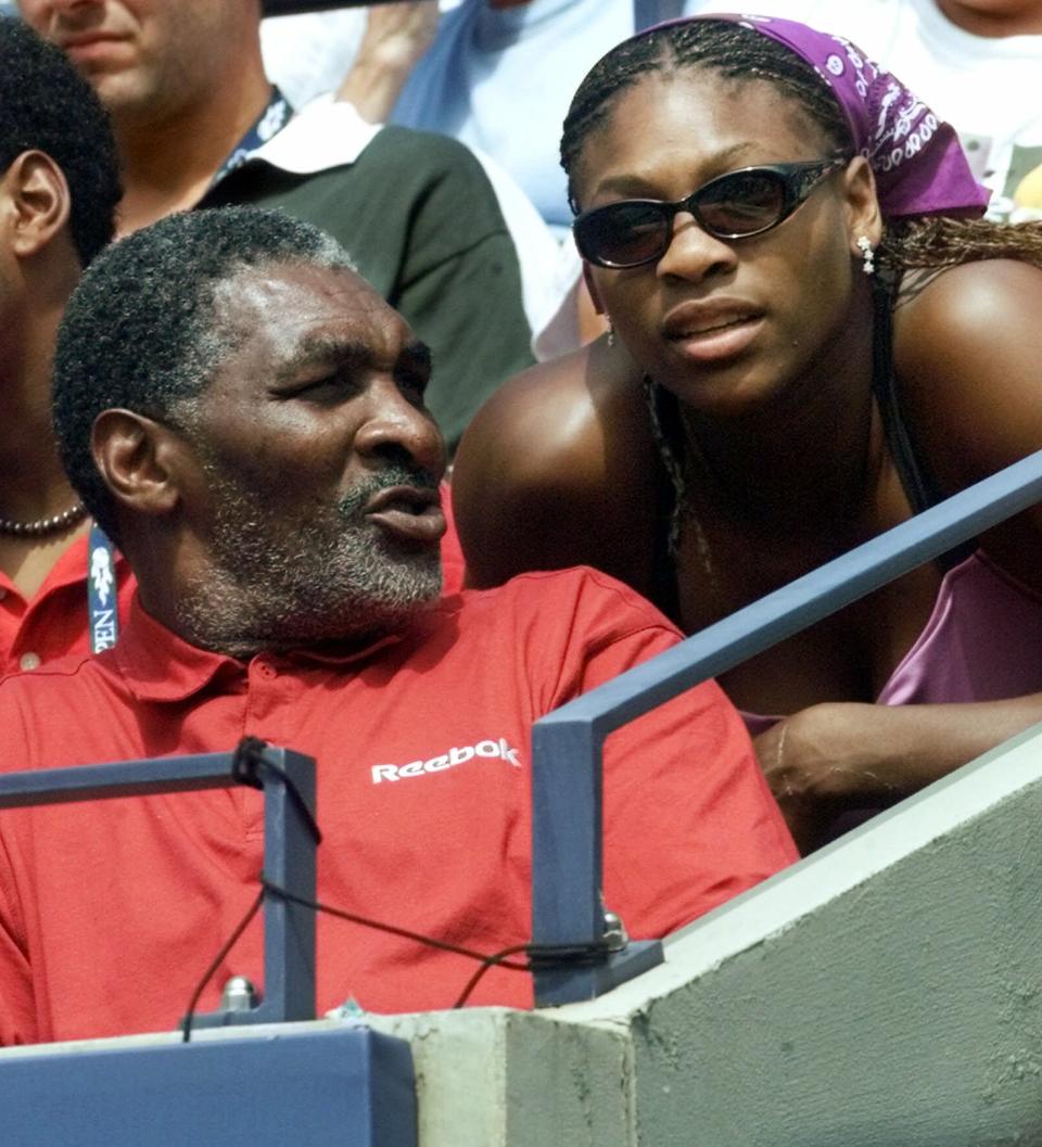 FILE - In this Aug. 30, 2000, file photo, Richard Williams, the father and coach of United States' Venus Williams, of Palm Beach Gardens, Fla., speaks with daughter Serena during Venus' match against the Czech Republic's Kveta Hrdlickova at the U.S. Open tennis tournament in New York. His new book, "Black and White: The Way I See It," comes out May 6. It goes into detail about how Indian Wells, as he writes, "disgraced America." (AP Photo/Suzanne Plunkett, File)