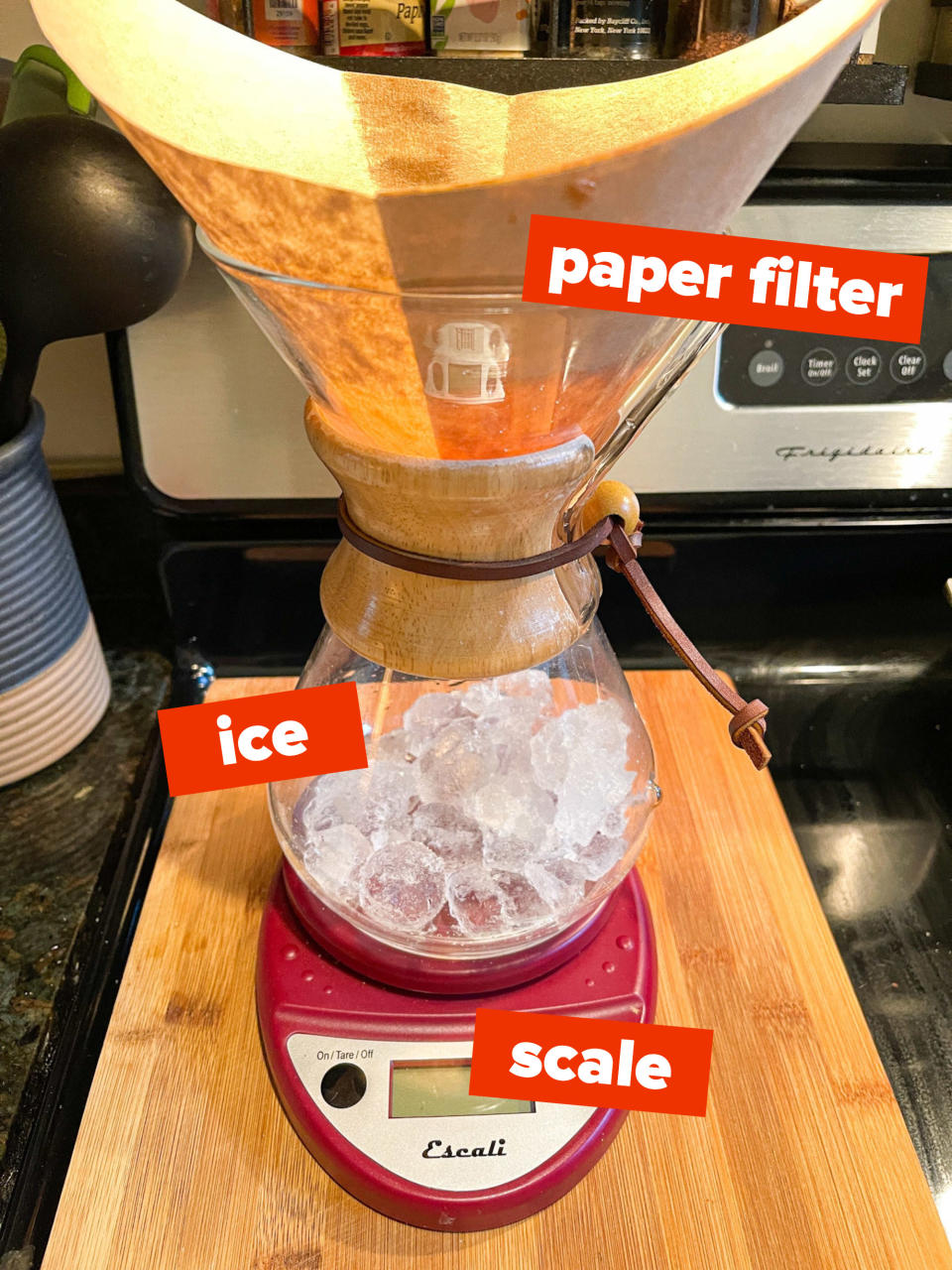 set up for Japanese iced coffee with a paper filter in the Chemex brewer, ice in the vessel, all on top of a scale