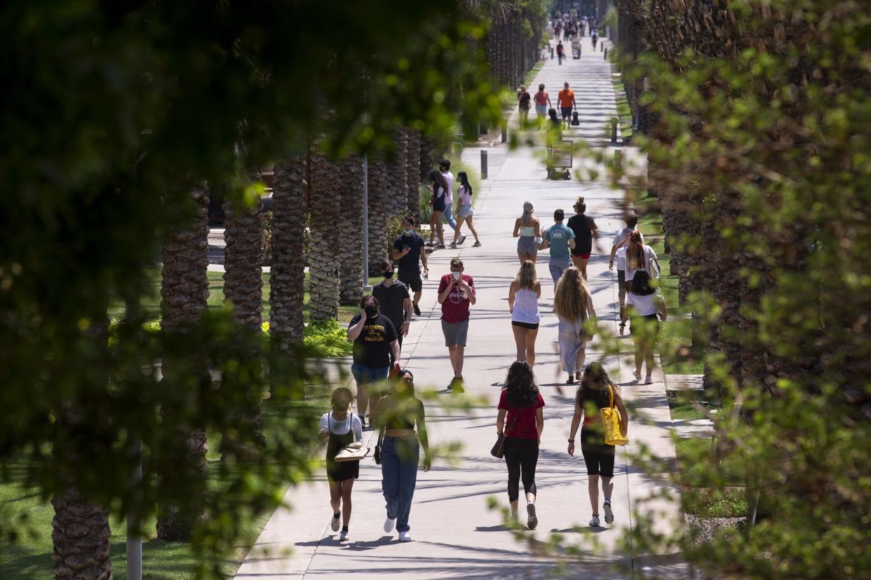 Students walk on campus the day before school opens on Aug. 19, 2020, at Arizona State University in Tempe.