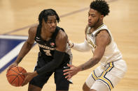 Providence's David Duke, left, looks to make his move against Villanova's Justin Moore, right, during the first half of an NCAA college basketball game Saturday, Jan. 23, 2021, in Villanova, Pa. (AP Photo/Chris Szagola)