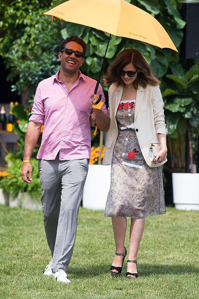 Bobby Cannavale (L) and Rose Byrne walking across the grass at the 2016 Veuve Clicquot Polo Classic