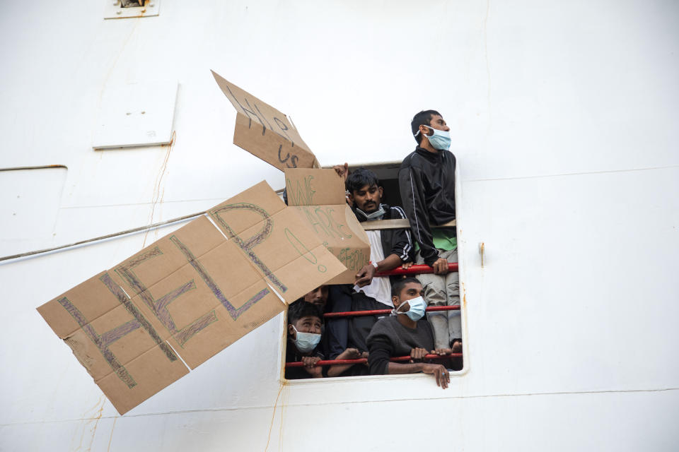 Migrants show placards demanding the disembark for all as the wait aboard of the Norway-flagged Geo Barents rescue ship , in Catania's port, Sicily, southern Italy, Tuesday, Nov. 8, 2022. This was the year war returned to Europe, and few facets of life were left untouched. Russia’s invasion of its neighbor Ukraine unleashed misery on millions of Ukrainians, shattered Europe’s sense of security, ripped up the geopolitical map and rocked the global economy. The shockwaves made life more expensive in homes across Europe, worsened a global migrant crisis and complicated the world’s response to climate change. (AP Photo/Massimo Di Nonno)