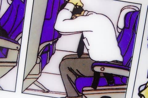 The "brace" position, as shown on an airline safety card - Credit: Alamy