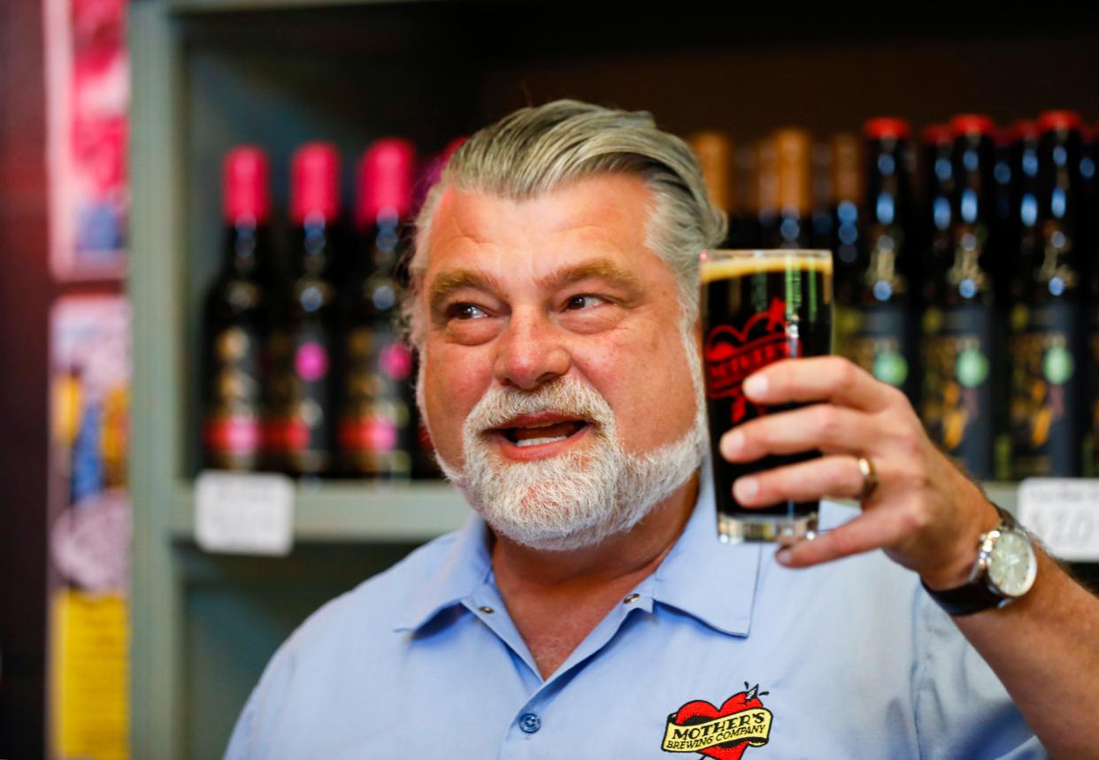 Jeff Schrag, formerly the chief executive officer and founder of Mother's Brewing Company, hoists a glass of Winter Grind while talking about selling the business to Jeff and Lindsay Seifried in the Mother's TapRoom on Wednesday, May 3, 2023.
