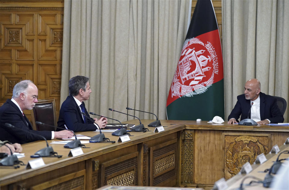 FILE - In this April 15, 2021, file photo Afghan President Ashraf Ghani, right, meets with U.S. Secretary of State Antony Blinken, second left, and their delegations, at the presidential palace in Kabul, Afghanistan. Blinken made an unannounced visit to Afghanistan to sell Afghan leaders and a wary public on President Joe Biden's decision to withdraw all American troops from the country and end America's longest-running war. (Afghan Presidential Palace via AP)