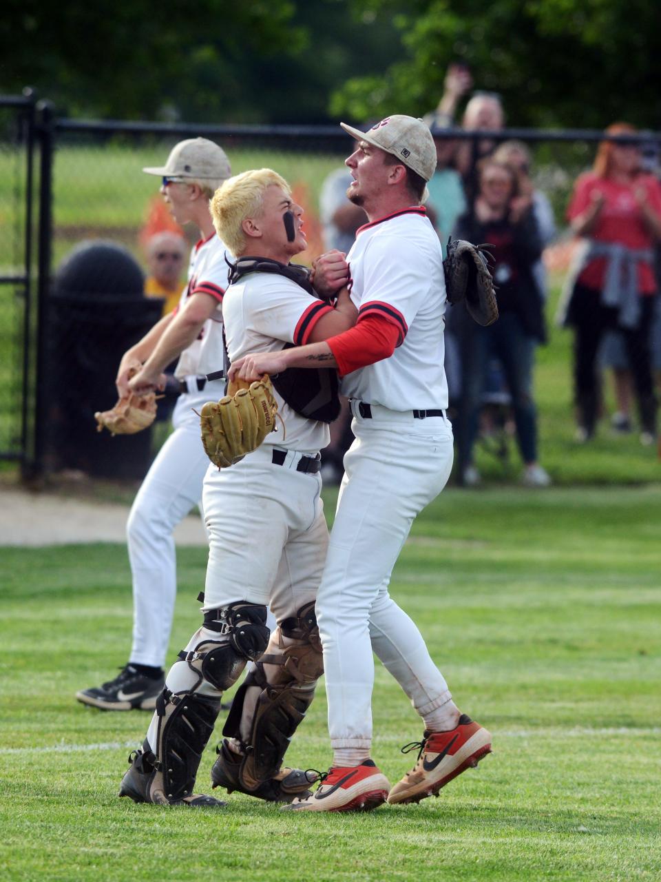 Liberty Union catcher Austin Ety, left, and pitcher Jacob Miller embrace after securing the final out of a 2-1 win against West Lafayette Ridgewood on Thursday in a Division III regional semifinal on Thursday at Mount Vernon High School.