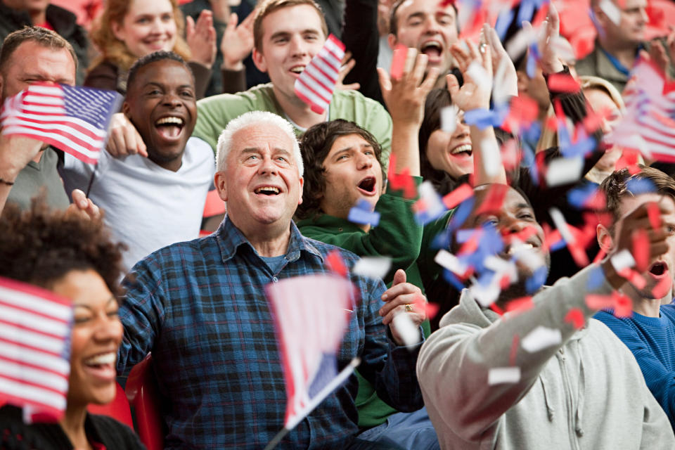 People waving American flags in a crowd