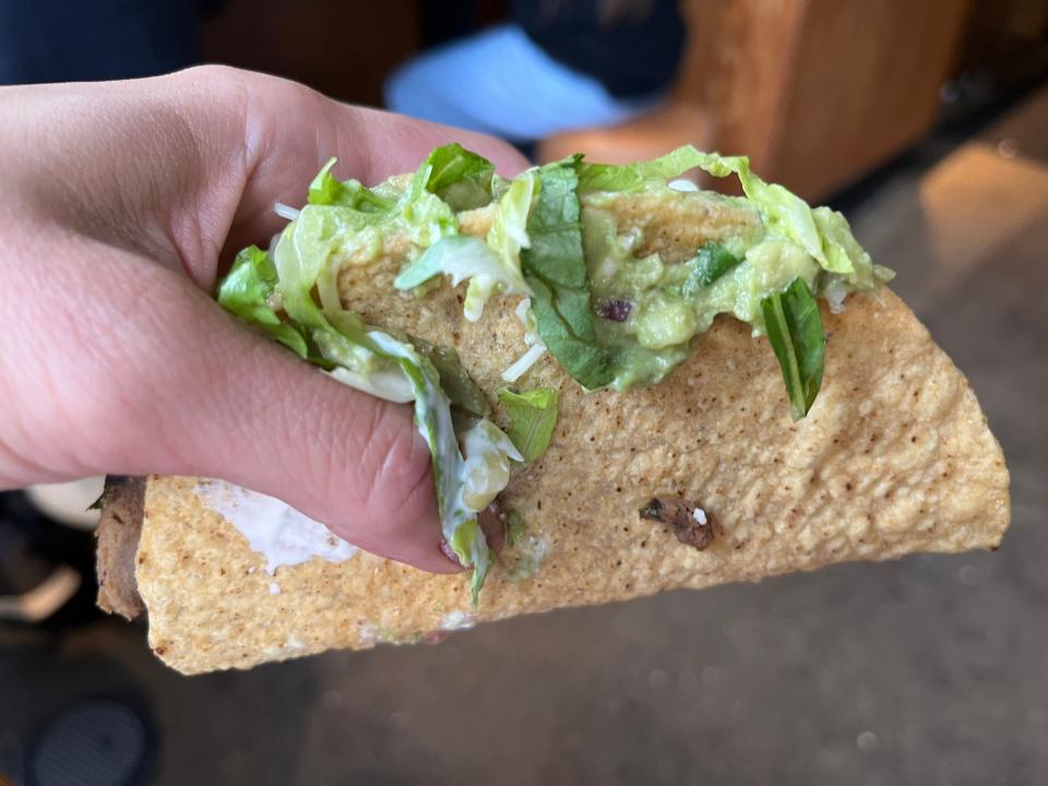 hand holding a steak taco from chipotle