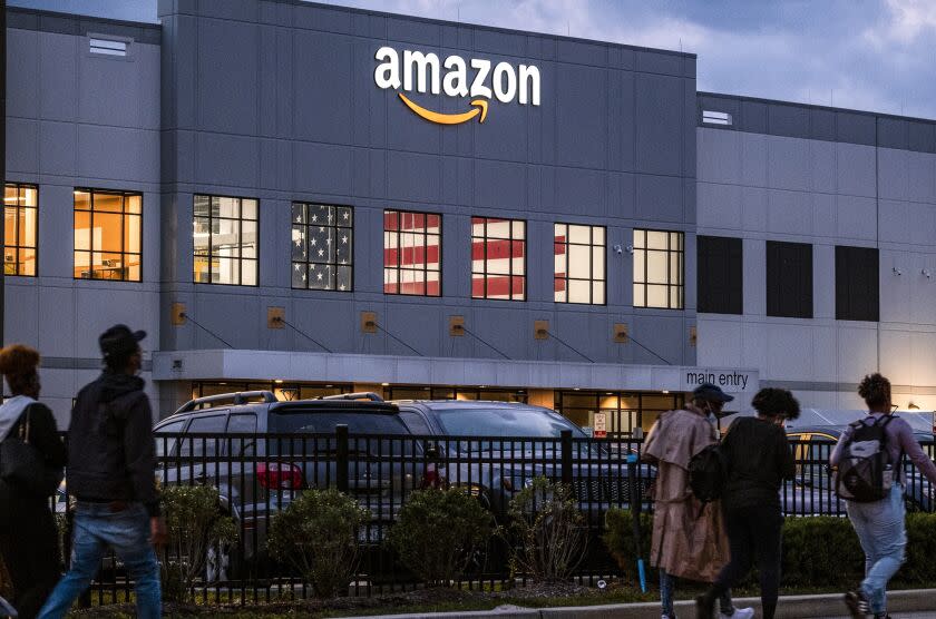 FILE - People arrive for work at the Amazon distribution center in the Staten Island borough of New York, on Oct. 25, 2021. Amazon plans to file objections to the union election on Staten Island, N.Y., that resulted in the first successful U.S. organizing effort in the company's history. The e-commerce giant stated its plans in a legal filing to the National Labor Relations Board made public Thursday, April 7, 2022. (AP Photo/Craig Ruttle, File)