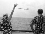 Queen Elizabeth II and the Duke of Edinburgh wave as Concorde flies by the Royal Yacht Britannia as the royal couple neared Barbados.