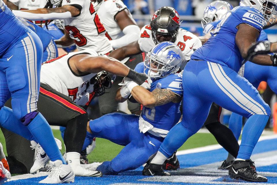 Detroit Lions running back Craig Reynolds (13) runs for a touchdown against Tampa Bay Buccaneers during the second half of the NFC divisional round at Ford Field in Detroit on Sunday, Jan. 21, 2024.