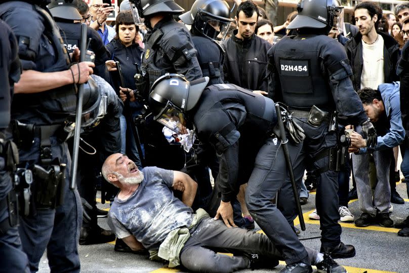 Police and demonstrators clash during a protest outside the Park Guell in Barcelona, Spain, 23 May 202.