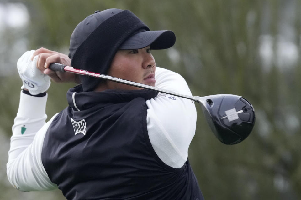 S.H. Kim, of South Korea, watches his tee shot on the third hole during the continuation of the second round of the Phoenix Open golf tournament Saturday, Feb. 10, 2024, in Scottsdale, Ariz. (AP Photo/Ross D. Franklin)