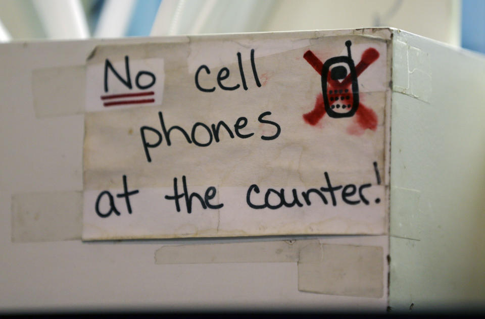 In this Friday, Oct. 5, 2012 photo, a sign at the Hamilton Street Cafe advises customers about cell phone policy at the restaurant, in Albany, N.Y. Cell phones may have morphed into ubiquitous appendages, but for nearly a generation now they've been an irritant in restaurants. But rather than let it eat away at them, some restauranteurs are getting strident about phone-free policies. (AP Photo/Mike Groll)