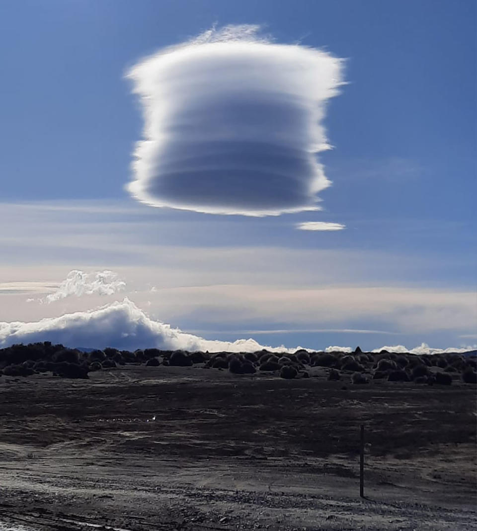 Lenticular cloud in sky over New Zealand near mountains. 